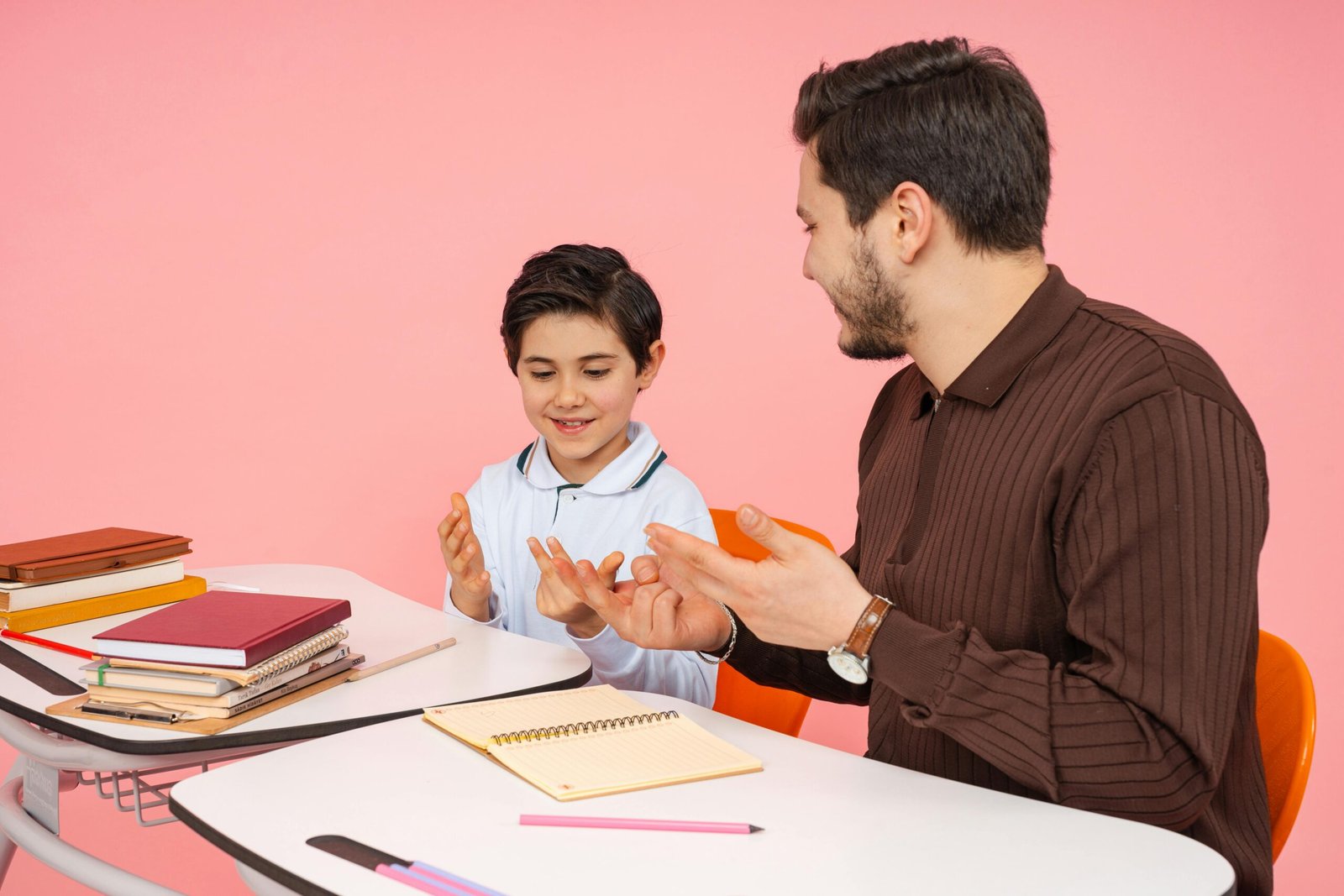 commercial-plumbing Male teacher and young student enjoying a learning session in a classroom.