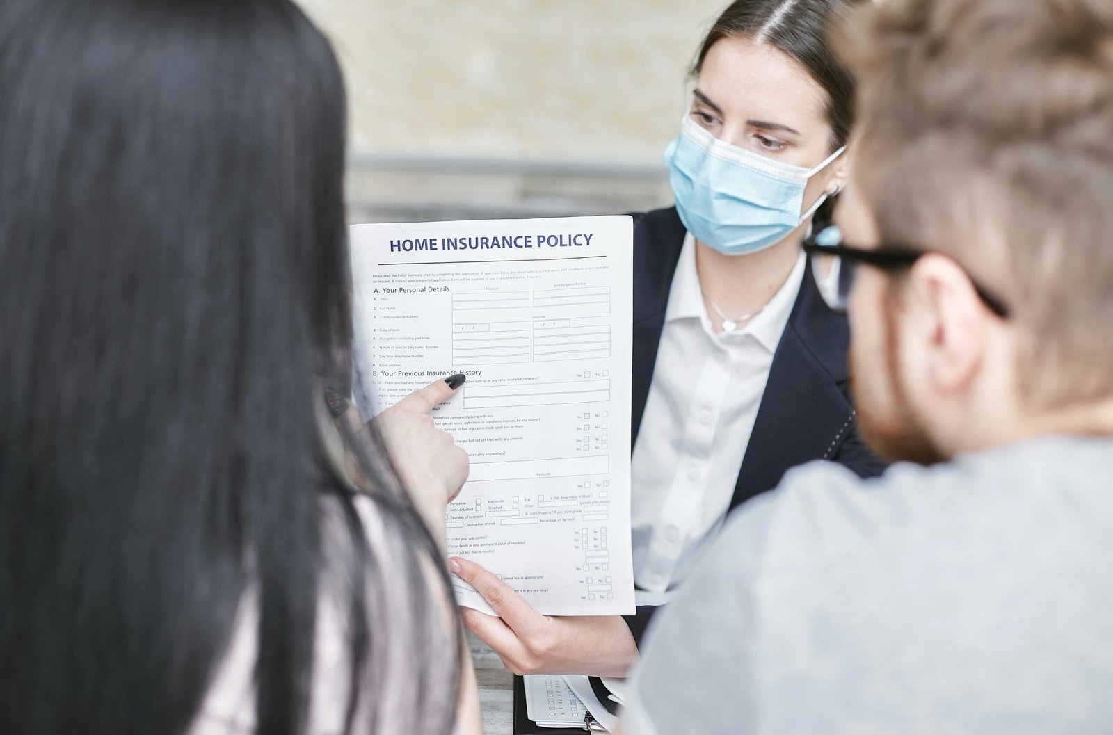 commercial-plumbing A professional woman explains a home insurance policy to clients during a meeting. Indoors setting.